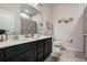 Elegant bathroom with double vanity, modern fixtures, and a shower, offering a luxurious and functional space at 17024 Goldcrest Loop, Clermont, FL 34714