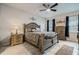 Comfortable bedroom featuring a ceiling fan, ornate furnishings, and plenty of natural light at 17024 Goldcrest Loop, Clermont, FL 34714