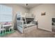 bedroom with white bunk beds, a small desk, and bright natural lighting at 17024 Goldcrest Loop, Clermont, FL 34714