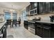 Well-equipped kitchen with stainless steel appliances and black cabinets at 17024 Goldcrest Loop, Clermont, FL 34714