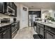 Spacious kitchen featuring stainless steel appliances, granite countertops, and dark cabinets, with a seamless design at 17024 Goldcrest Loop, Clermont, FL 34714