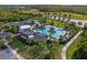 Beautiful aerial view of the community pool, amenity center, and a scenic lake at 17024 Goldcrest Loop, Clermont, FL 34714