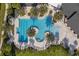 Overhead view of the community's pool area, featuring palm trees and comfortable lounge seating at 17024 Goldcrest Loop, Clermont, FL 34714