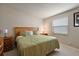 This bedroom features a neutral color palette, a comfortable bed, and natural light at 1729 Lauren Ln, Lady Lake, FL 32159