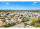 An aerial image captures a suburban neighborhood with well-maintained homes and lush landscaping at 1797 Pamplico Ct, The Villages, FL 32162