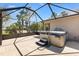 Back porch features a private hot tub with steps, all encased within a screened-in enclosure at 1797 Pamplico Ct, The Villages, FL 32162