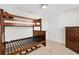 Bedroom featuring bunk beds, dresser, and neutral walls, creating a versatile space at 1797 Pamplico Ct, The Villages, FL 32162