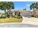 Well-maintained front yard with lush landscaping leads to a charming single-story home at 1797 Pamplico Ct, The Villages, FL 32162