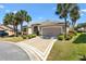 Beautiful single-story home with a manicured front yard and a spacious driveway leading to a two-car garage at 1797 Pamplico Ct, The Villages, FL 32162