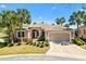 Charming one-story home featuring a lush lawn, mature landscaping and an attached two-car garage at 1797 Pamplico Ct, The Villages, FL 32162