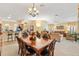 Open floor plan with views into the kitchen and living room, and dining table at 1797 Pamplico Ct, The Villages, FL 32162