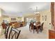 A spacious living area connects to a dining space with sliding glass doors to the outdoors at 1797 Pamplico Ct, The Villages, FL 32162