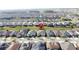 The photograph shows an aerial shot of single-Gathering homes in a planned community, showcasing mature trees and ponds at 203 Silver Maple Rd, Groveland, FL 34736