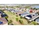 An aerial view of several single-Gathering homes showcasing mature lawns and a lovely neighborhood with solar panels at 203 Silver Maple Rd, Groveland, FL 34736