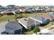 Aerial view of backyard and patio in residential neighborhood at 203 Silver Maple Rd, Groveland, FL 34736