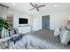 Relaxing main bedroom with a ceiling fan, TV, dresser and a decorative chair at 203 Silver Maple Rd, Groveland, FL 34736