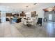 Open dining area featuring modern lighting, tile flooring, and easy kitchen access at 203 Silver Maple Rd, Groveland, FL 34736