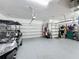 Large three-car garage with epoxy flooring and overhead storage at 203 Silver Maple Rd, Groveland, FL 34736