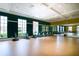 Well-lit gym equipped with stationary bikes, large windows, and mirrored walls at 203 Silver Maple Rd, Groveland, FL 34736