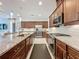 Well-equipped kitchen featuring granite countertops, stainless steel appliances, and tile backsplash at 203 Silver Maple Rd, Groveland, FL 34736