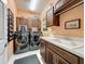 Practical laundry room featuring modern washer and dryer set, plus plenty of storage cabinets and counterspace at 203 Silver Maple Rd, Groveland, FL 34736