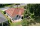 Aerial view of the back of a cozy home with a screened in porch and patio seating area at 2068 Darlington Dr, The Villages, FL 32162