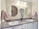 Bathroom featuring double sinks and a granite counter at 2068 Darlington Dr, The Villages, FL 32162