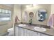 Bright bathroom with double sinks, granite countertops, and decorative mirrors at 2068 Darlington Dr, The Villages, FL 32162