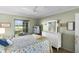 Bedroom featuring dresser, a window overlooking the garden, and a ceiling fan at 2068 Darlington Dr, The Villages, FL 32162