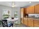 A kitchen eating area features black and green wooden chairs with a white table at 2068 Darlington Dr, The Villages, FL 32162