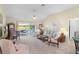 Comfortable living room featuring neutral colors, ceiling fan, and access to the outdoors at 2068 Darlington Dr, The Villages, FL 32162