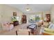 Living Room with neutral colored furniture and a sliding glass door to the lanai at 2068 Darlington Dr, The Villages, FL 32162