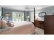 Cozy main bedroom boasting neutral colors and view to a private backyard at 2068 Darlington Dr, The Villages, FL 32162