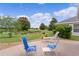 Outdoor patio seating with views of the lush green golf course and manicured landscaping at 2068 Darlington Dr, The Villages, FL 32162