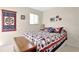 Nicely decorated bedroom with patriotic decorations and a colorful quilt bedspread at 20751 Queen Alexandra Dr, Leesburg, FL 34748