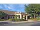 Clubhouse exterior with elegant architecture and lush landscaping, showcasing community amenities at 20751 Queen Alexandra Dr, Leesburg, FL 34748