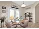 Cozy dining area featuring tile floors, a wooden table, and access to the outdoors at 20751 Queen Alexandra Dr, Leesburg, FL 34748