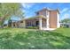 Exterior view of the home with a screened lanai overlooking the beautiful backyard at 20751 Queen Alexandra Dr, Leesburg, FL 34748