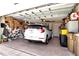 Spacious garage featuring a white SUV, ample storage, and well-organized tools along the wall at 20751 Queen Alexandra Dr, Leesburg, FL 34748