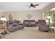 Spacious living room featuring neutral tones, carpet flooring and comfortable furnishings at 20751 Queen Alexandra Dr, Leesburg, FL 34748