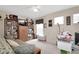 Comfortable living room featuring a large bookshelf, a sofa, and a window for natural light at 20751 Queen Alexandra Dr, Leesburg, FL 34748