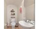 Cozy powder room featuring neutral paint, a decorative mirror and updated fixtures at 20751 Queen Alexandra Dr, Leesburg, FL 34748