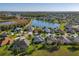 Aerial view of community showing homes, a lake and lush landscaping at 27023 Old English Ct, Leesburg, FL 34748