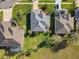 Aerial view of a home with lush green lawn, mature landscaping and spacious backyard at 27023 Old English Ct, Leesburg, FL 34748