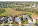 Aerial view highlighting the property within its neighborhood, featuring well-kept lawns and mature landscaping at 27023 Old English Ct, Leesburg, FL 34748