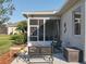 Back patio with screened in area and room for outside seating at 27023 Old English Ct, Leesburg, FL 34748