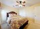 Inviting bedroom showcasing a plush bed, soft lighting, and a ceiling fan, creating a cozy retreat space at 27023 Old English Ct, Leesburg, FL 34748