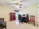 Cozy bedroom with ceiling fan, a functional desk setup, and a classic dresser, perfect for a home office at 27023 Old English Ct, Leesburg, FL 34748