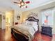 Large bedroom with decorative headboard, ceiling fan, and lots of natural light at 27023 Old English Ct, Leesburg, FL 34748