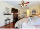 Spacious bedroom with dark wood floors, ceiling fan, and ample closet space at 27023 Old English Ct, Leesburg, FL 34748